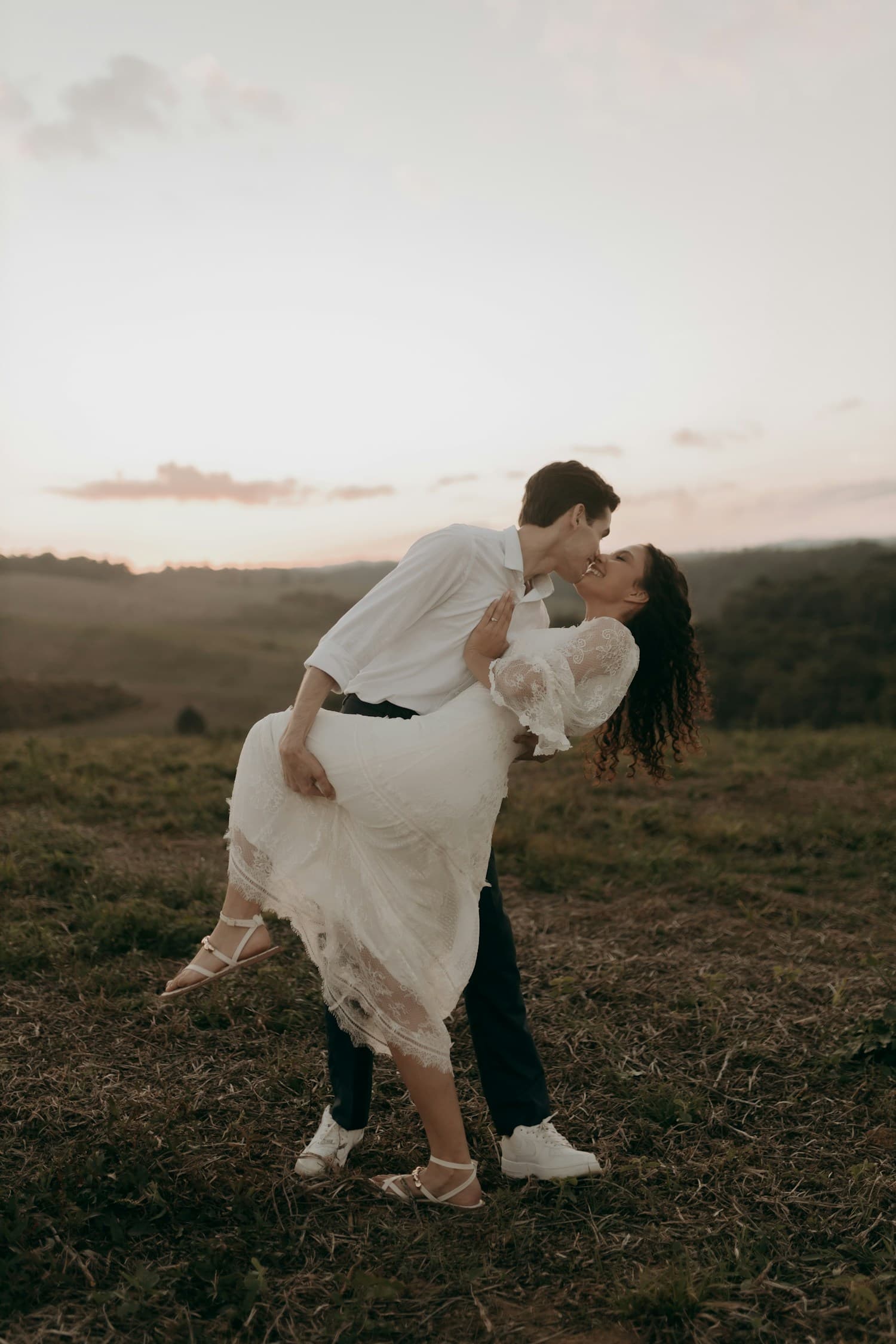 A couple sharing a joyful moment outdoors at sunset